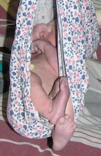 Photograph of baby Ella being weighed.
